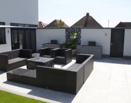Contemporary garden design with granite two tone paving and bespoke mirror, water features and fire pit