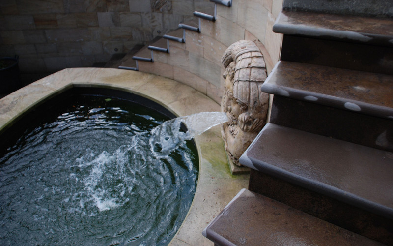 Classic traditional style water feature using a hand carved marble water God that discharges water into the pool below