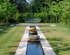 Garden water feature designed with a long rill dressed with French Limestone